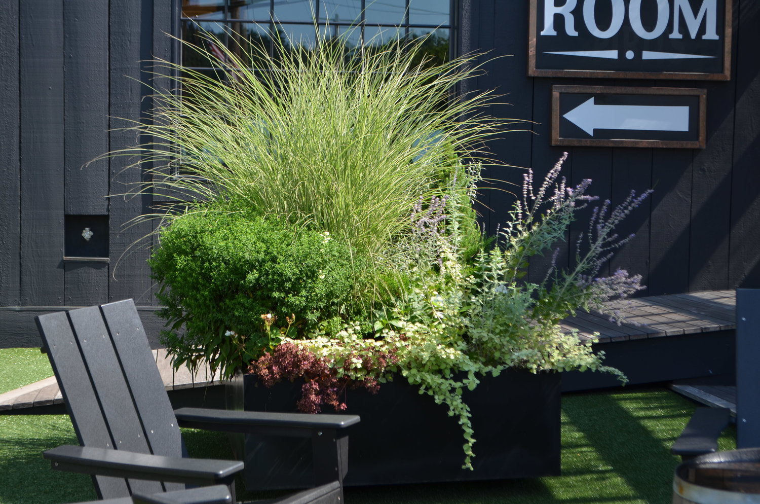 A spray of native grasses decorates a planter in front of Catskill Provisions Distillery.